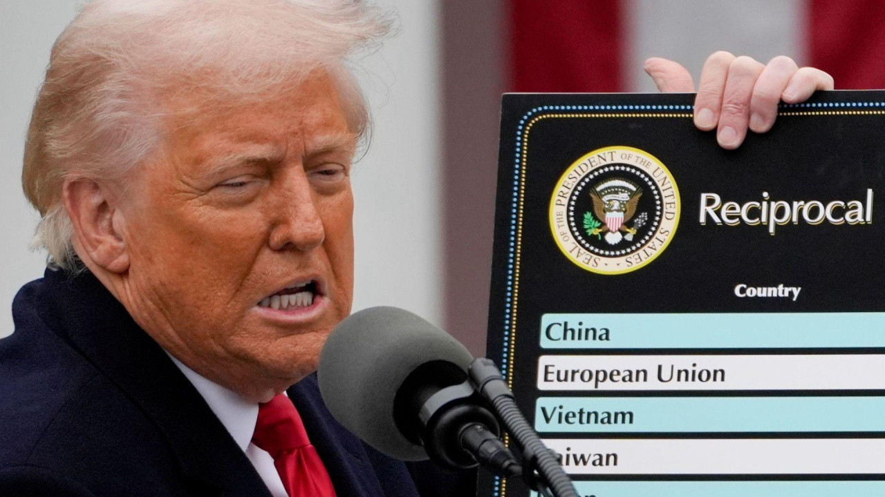 
                    US President Donald Trump speaks while holding a board with titled ‘Reciprocal Tariffs’ that list planned tariff rates during an announcement in the Rose Garden of the Wh