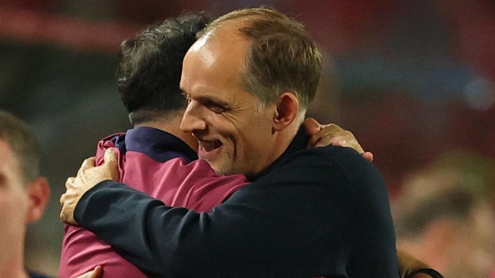 England head coach Thomas Tuchel is embraced by a member of his backroom team after the 5-0 win against Serbia in Belgrade