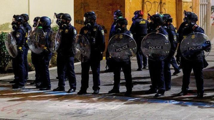 
                    ICE agents stand guard during a protest against the Trump administration's immigration policies, outside an ICE detention facility in Portland, Oregon, on 01 September, 2