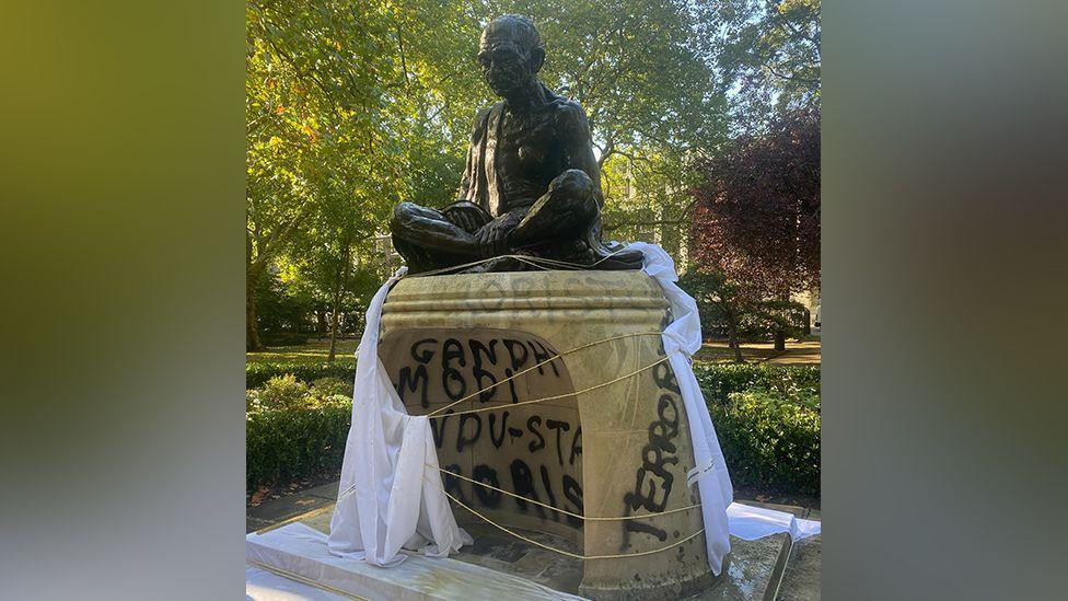 Graffiti on statue of independence hero Mahatma Gandhi in Tavistock Square, London 30 September 2025