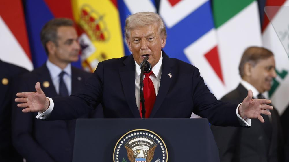 US President Donald Trump, standing at podium, delivering a speech at a summit in Sharm El-Sheikh, Egypt. 