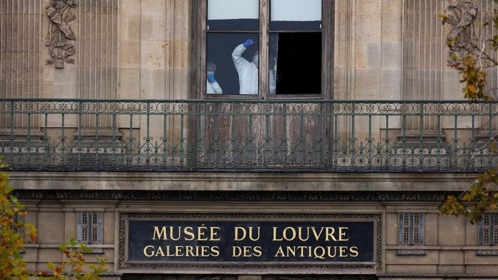 Pripadnici forenzičkog tima pregledaju prozor kroz koji su lopovi upali u muzej Luvr i opljačkali ga