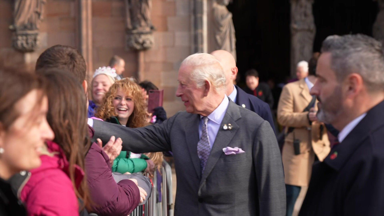 A picture of King Charles greeting fans outside a cathedral