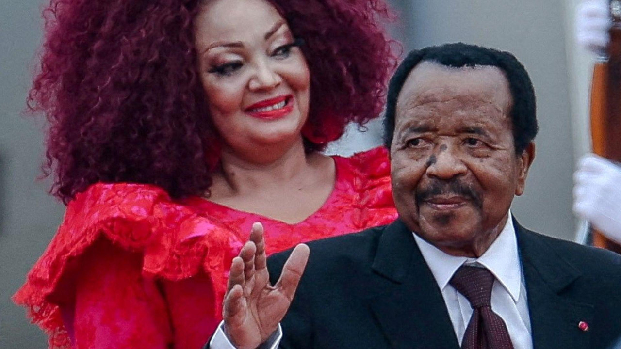 
                    Cameroon's President Paul Biya in black suit, white shirt with maroon colour tie waves as he arrives at the Beijing Capital International Airport, to attend Summit of the