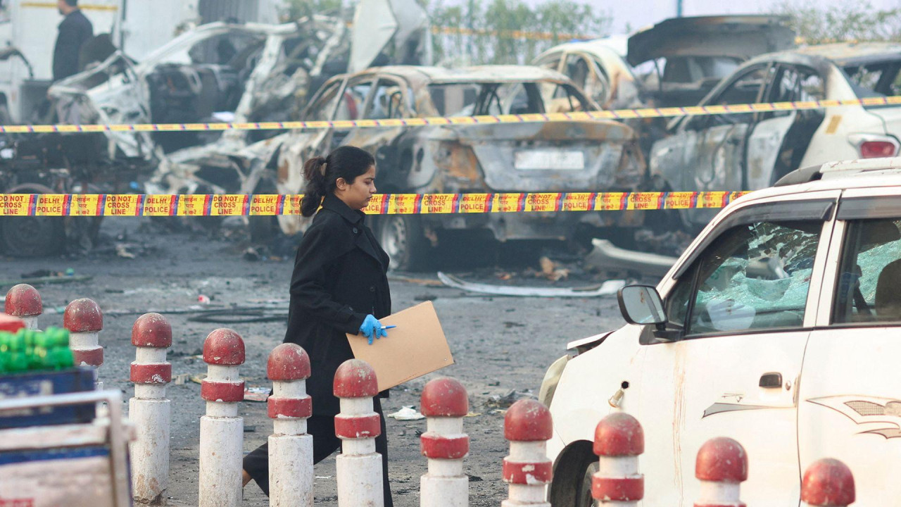 A member of the forensic team work at the site of an explosion near the historic Red Fort in the old quarters of Delhi, India, November 11, 2025. 