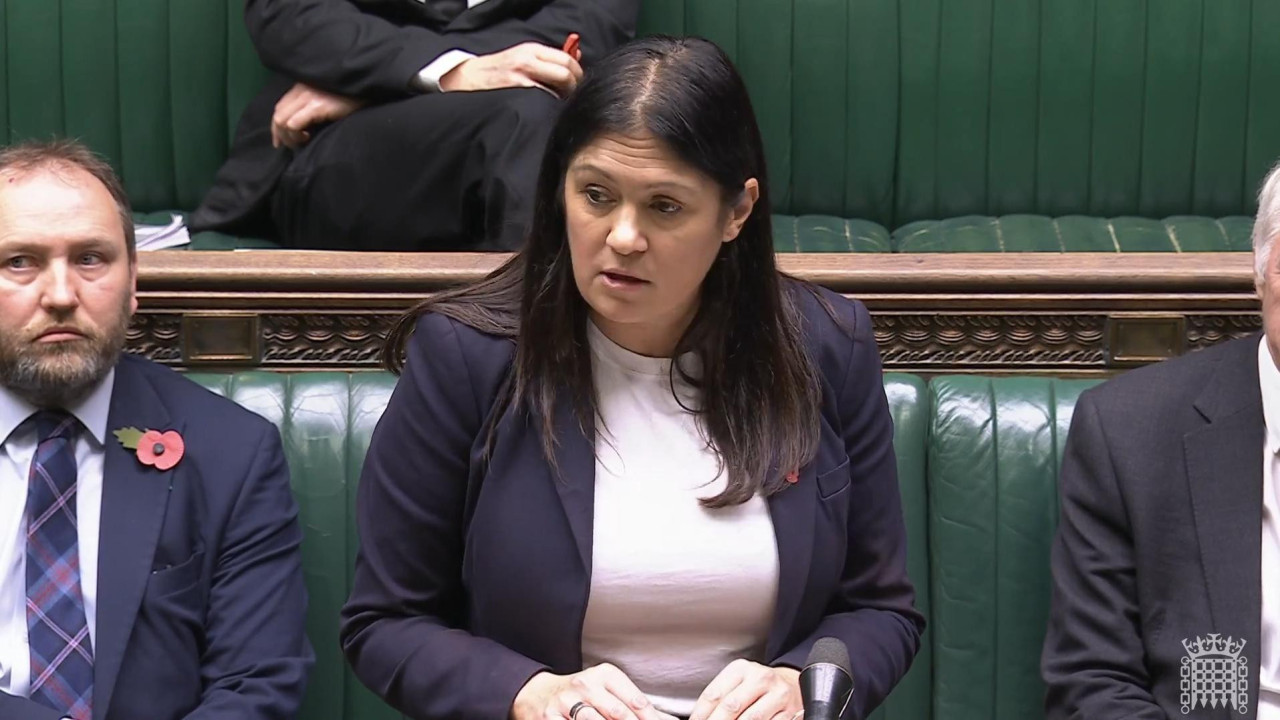 Liza Nandi u britanskom parlamentu u teget sakou između dva poslanika