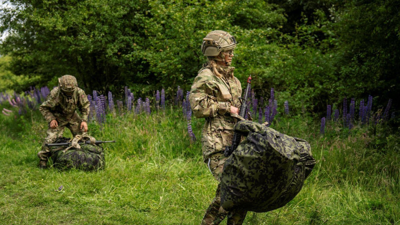 regrutkinja u danskoj vojsci, nosi vojnu uniformu, šlem, pušku i veliku torbu 