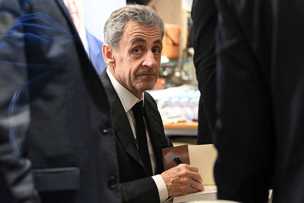 
                    France's former President Nicolas Sarkozy looks on as he takes part in an autograph session of his book "Diary of a Prisoner" on the day of its' release at the Lamartine 