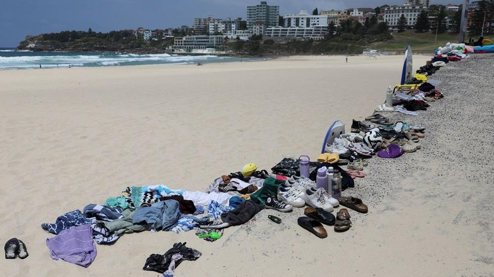 pucnjava u australiji, stvari ubijenih i ranjenih poređane na plaži, patike i odeća poređani na plaži
