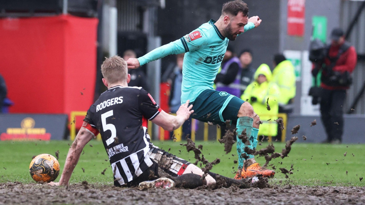 Wolves' Adam Armstrong challenges for a ball against Grimsby Town's Harvey Rodgers