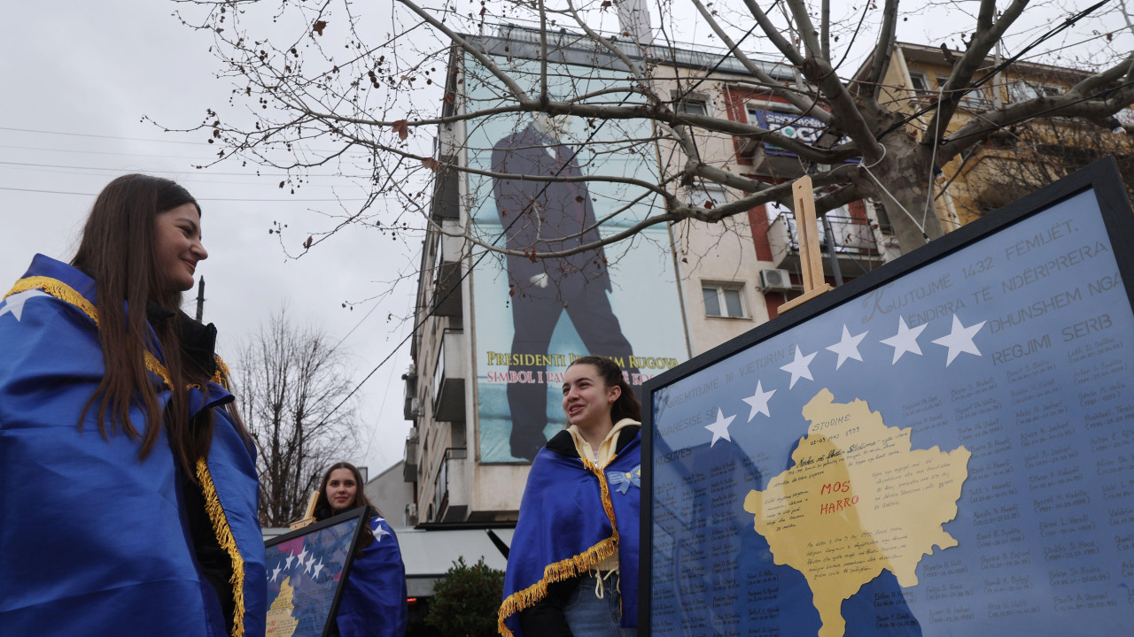 Devojke ogrnute kosovskim zastavama stoje pored panela sa imenima žrtava srpskog režima tokom proslave 18. godišnjice nezavisnosti zemlje u Prištini, Kosovo, 17. februara 2026. 
