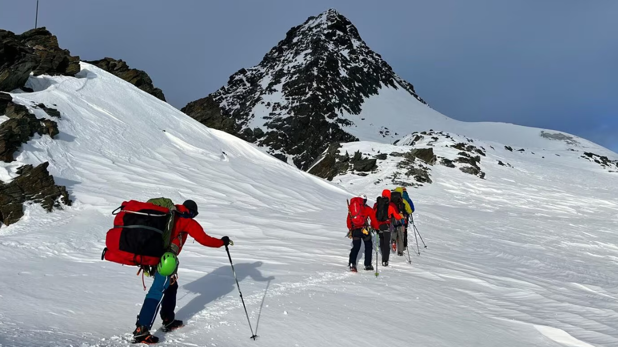 Mountain rescue teams walk through the snow in Austria