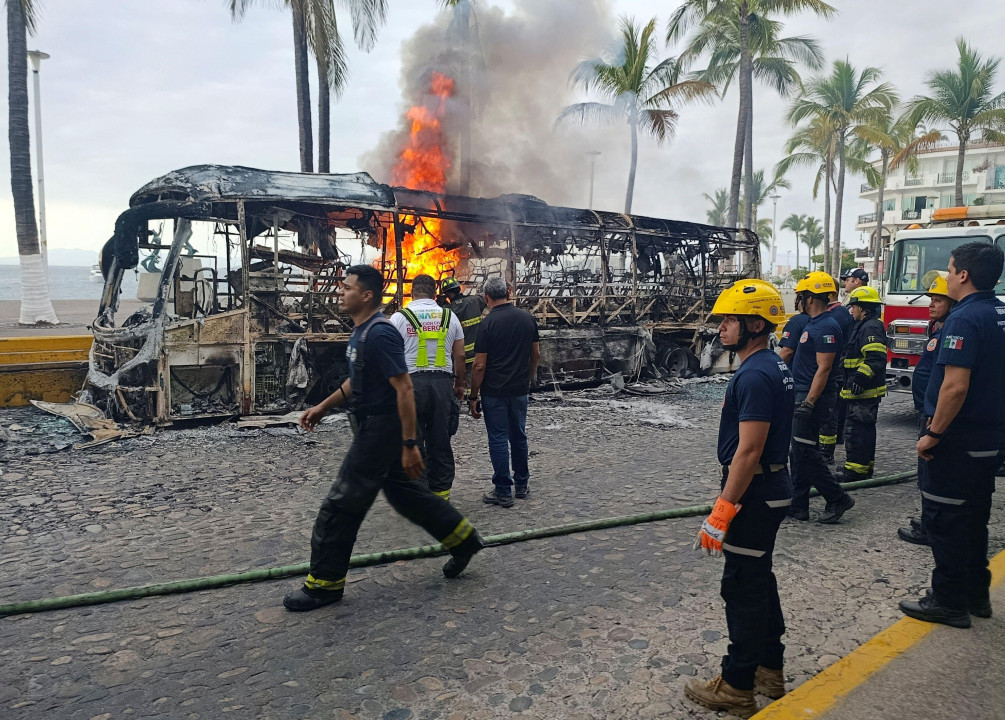 Firefighters work to put out a bus on fire in Puerto Vallarta, Mexico.