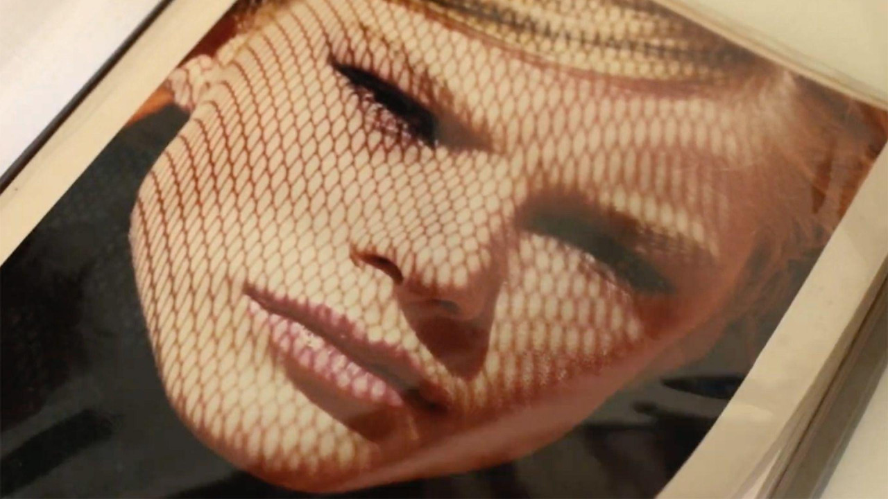 Picture in an album showing an artistic headshot of a young blonde woman looking into the camera.