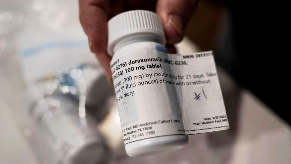Close up image shows a pill bottle labelled daraxonrasib, in view are some of the label contents such as '300 mg' and 'by mouth daily for 21 days'.