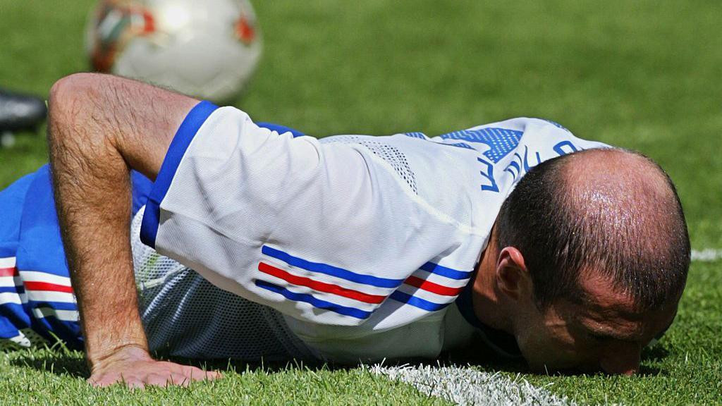 France footballer Zinedine Zidane lies face down on the pitch of the Incheno Stadium in Seoul, South Korea, during his side's 2-0 defeat to Denmark in the 2002 World Cup.