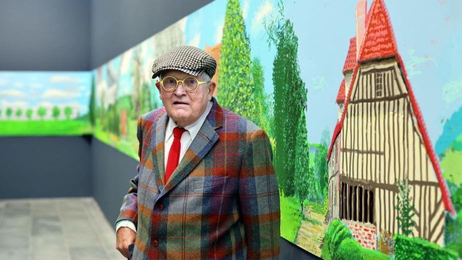 David Hockney stands alongside his 91m long landscape of Normandy, completed during the coronavirus lockdown