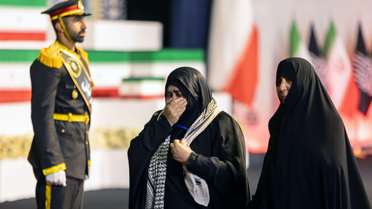 Women react near the coffins of Iran's late Supreme Leader Ayatollah Ali Khamenei and his family members.