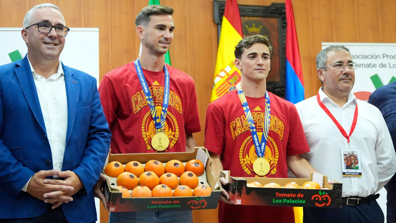 Četiri muškarca, jedan u plavom odelu, u sredini dvojica u dresu španske reprezentacije i medaljama oko vrata i na kraju stariji čovek u beloj košulji
