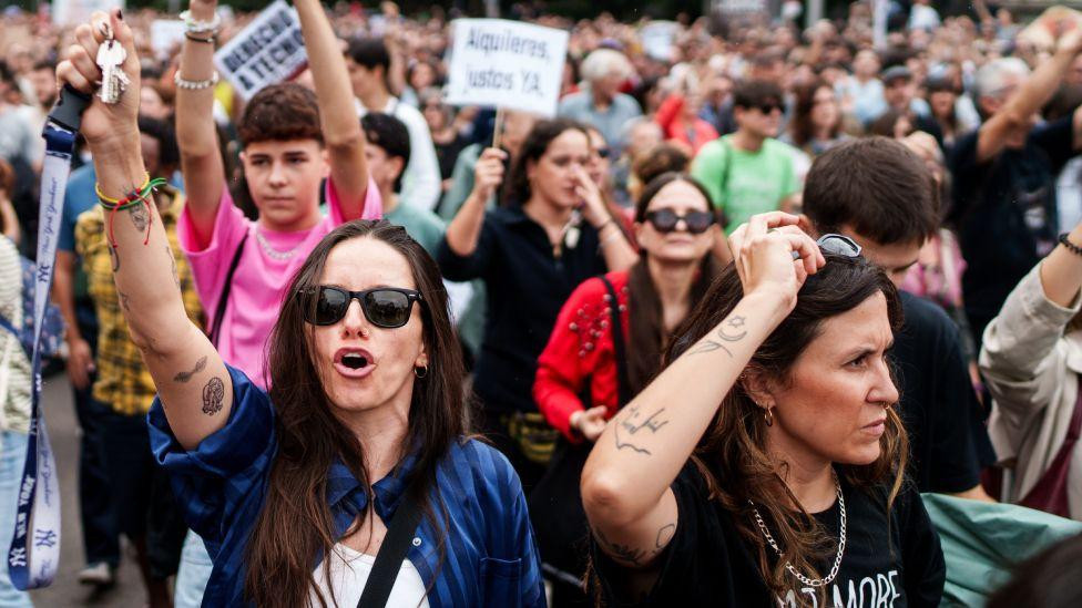 Protesters march through Madrid, with two women in front
