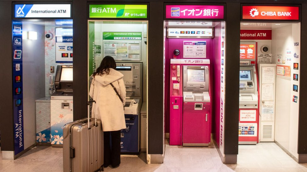 Woman withdrawing money from an ATM