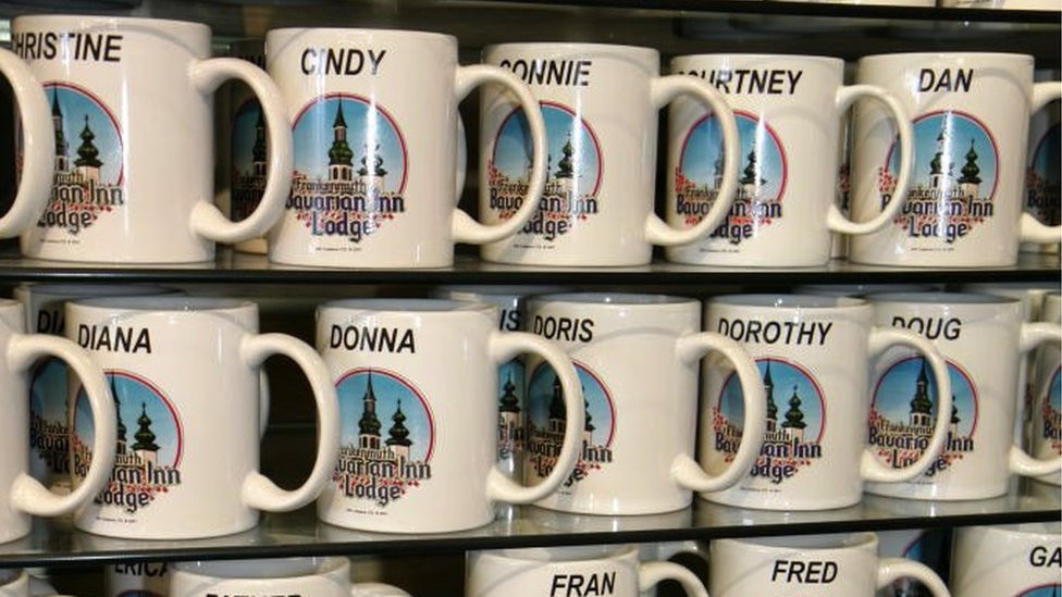Named mugs for sale on a shop shelf