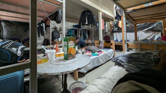 skromna baraka radnika u kojoj su krevet i razbacane stvari