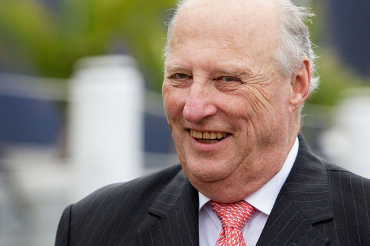King Harald smiles at the camera.